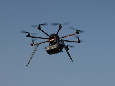 A black drone in air