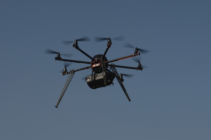 A black drone in air