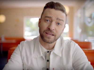 Justin Timberlake sitting at a diner table in his "Can't Stop the Feeling" music video