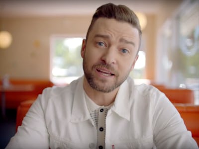 Justin Timberlake sitting at a diner table in his "Can't Stop the Feeling" music video