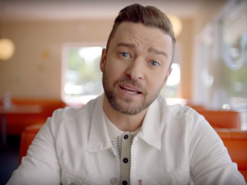 Justin Timberlake sitting at a diner table in his "Can't Stop the Feeling" music video
