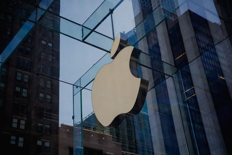 Large golden logo of Apple company on a building