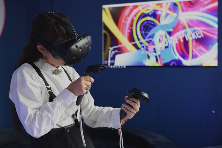 A person using the VR glasses and joysticks