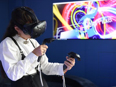 A person using the VR glasses and joysticks