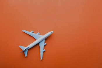 A model plane placed on an orange surface