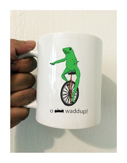 A white mug with a frog on an unicycle 