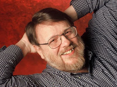 Ray Tomlinson, the Inventor of Email, posing in a black and white checked shirt and glasses