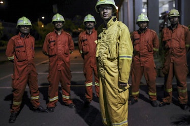 Fire fighters stand for photograph at the Vadinar Refinery complex operated by Nayare Energy Ltd.