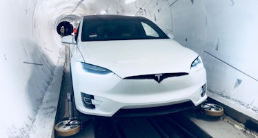 A Tesla Model X, fitted with the necessary guide wheels, inside The Boring Company's tunnel.