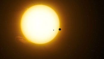 This artist's rendering shows what it may look like for the planet Kepler-1625b and its moon Kepler-...