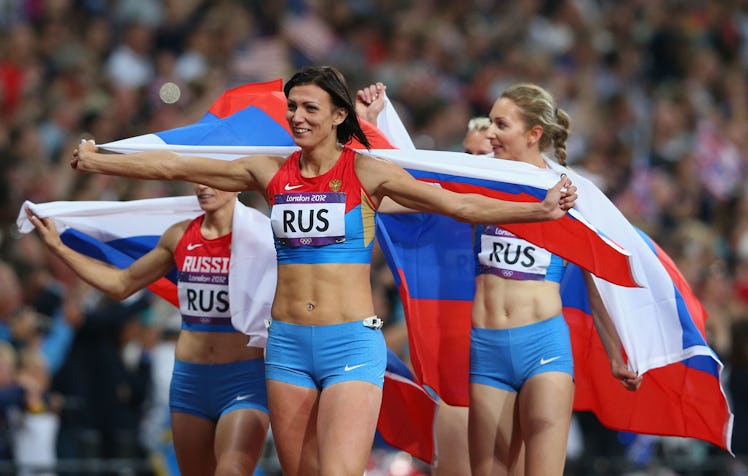 Russian athlete Natalya Antyukh celebrating a win with a Russian flag