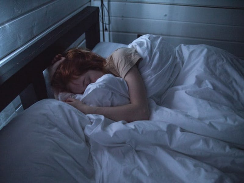 Woman peacefully sleeping in her bed