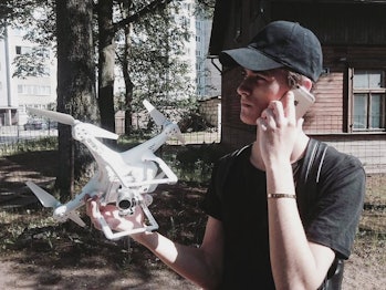 Geskin holding a drone.