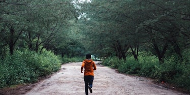 A woman running through a forest  