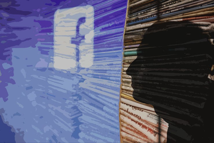 A shadow looking through a window with the Facebook logo on it