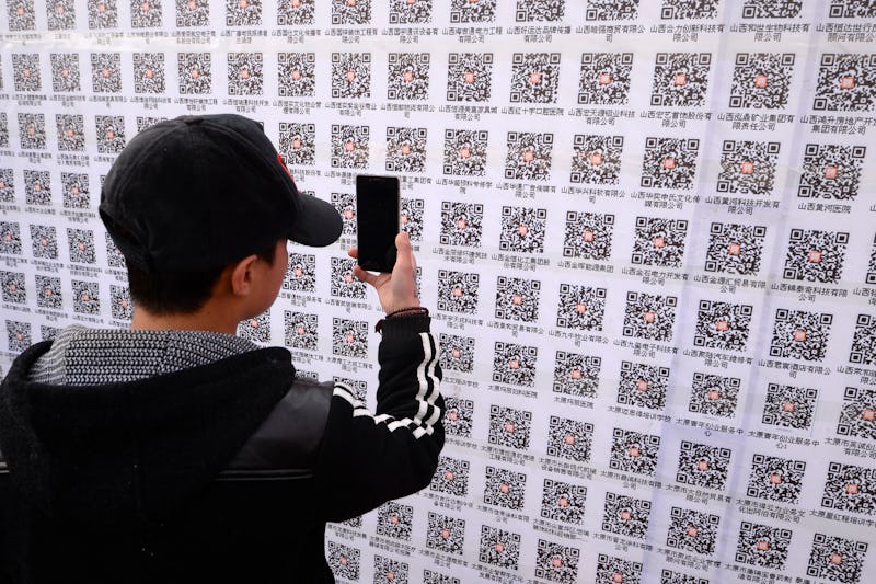 An attendee scanning QR codes at 2015 job fair in Taiyuan, China.