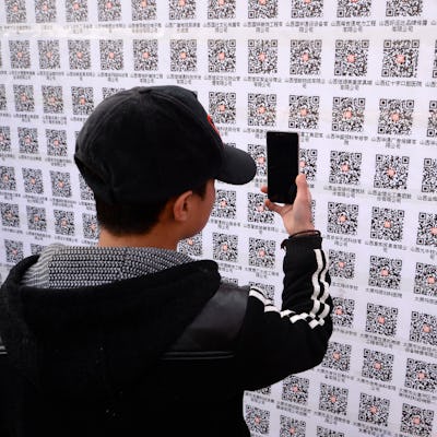 An attendee scanning QR codes at 2015 job fair in Taiyuan, China.