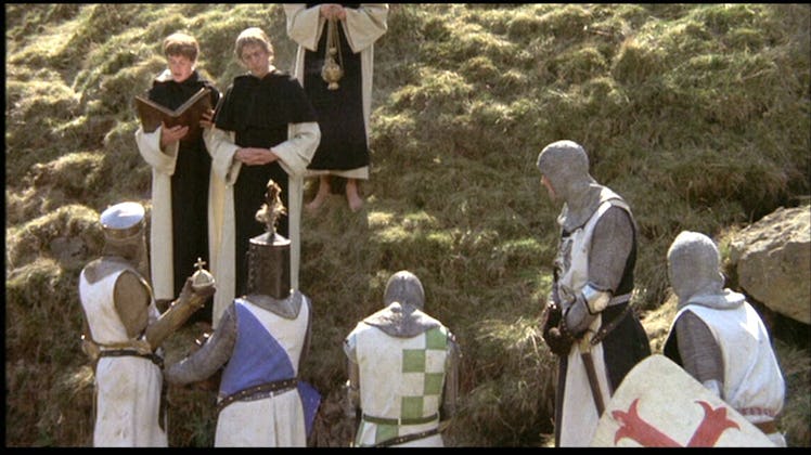King Arthur holding the Holy Hand Grenade listening to the instructions.