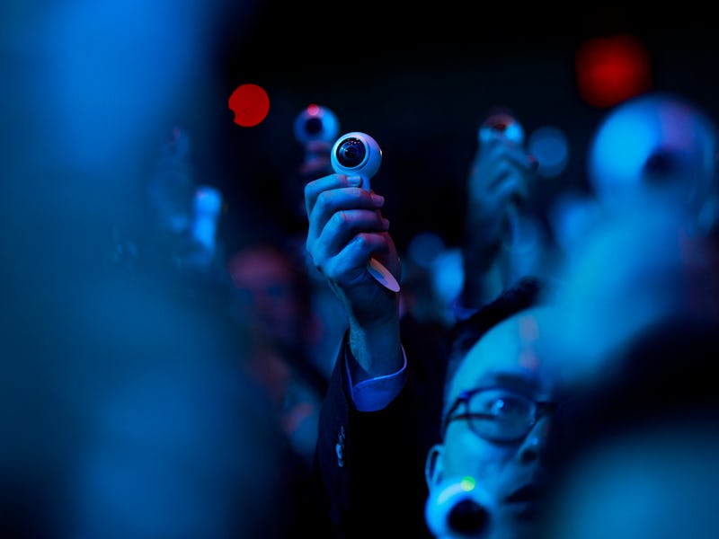 A crowd with people using cameras because of their tech addiction