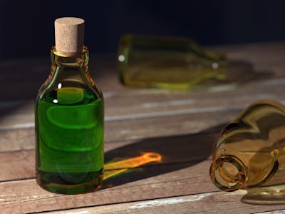 A glass bottle full of green liquid