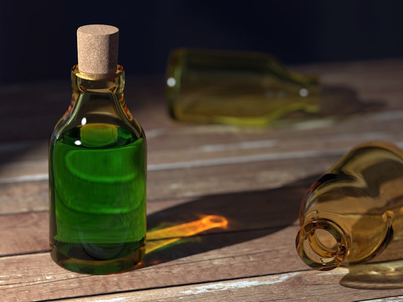 A glass bottle full of green liquid