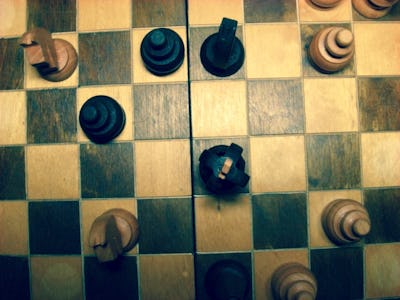 A view of a chessboard with chess pieces from above