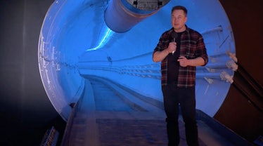 Musk standing next to his "wormhole" tunnel