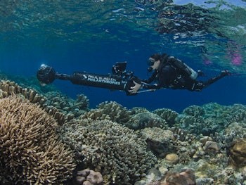 A man snorkeling and using A.I. and 360-cameras to save coral reefs