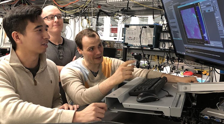 (From left) graduate students Kevin Miao, Chris Anderson, and Alexandre Bourassa conduct quantum exp...