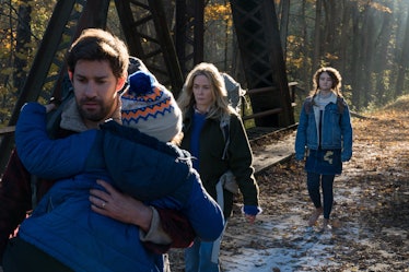 Lee Abbott (John Krasinski) carries his son Marcus (Noah Jupe) with his wife Evelyn (Emily Blunt) an...