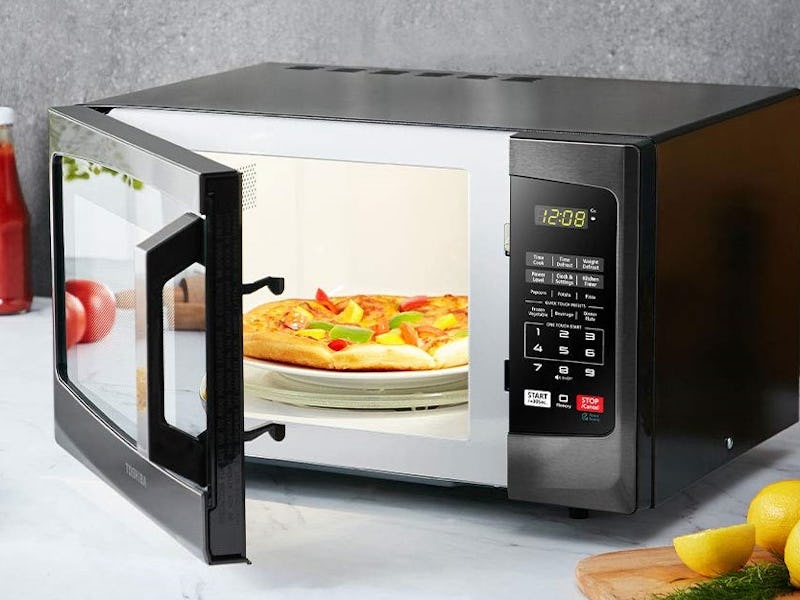 The Toshiba EM925A5A-BS Microwave Oven slightly open with a pizza in it.