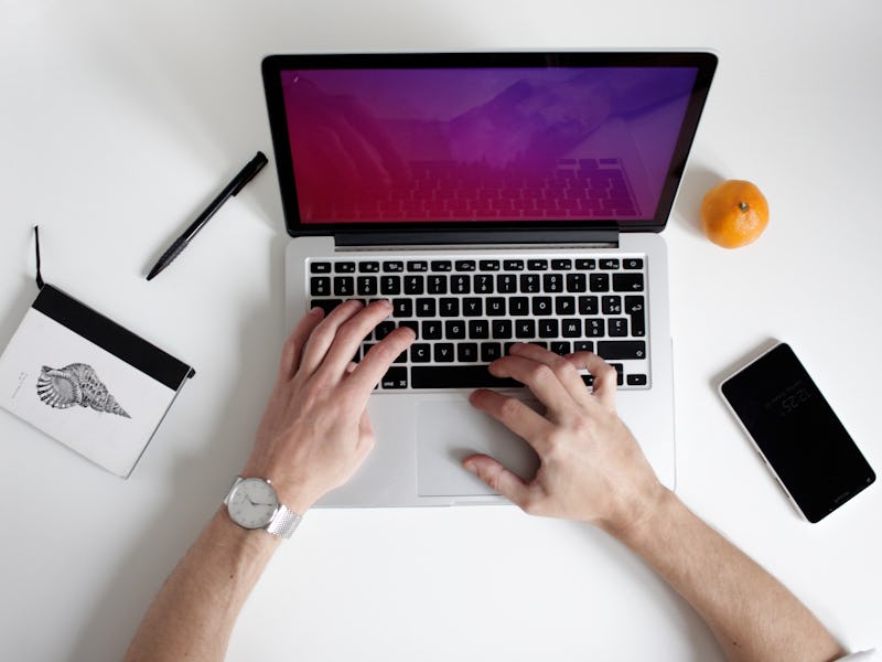 A person typing on the laptop while trying to find best VPN Service for speed
