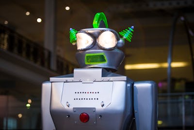 A robot with a purple head and green spikes 