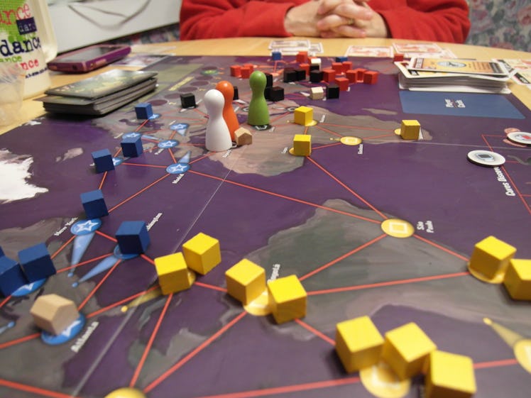 Pandemic board game set on a table during a game