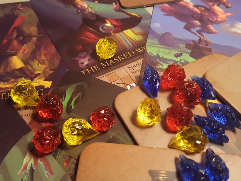 The board game 'Apotheca' opened and placed on a table with all the playing elements