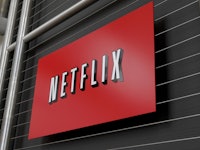 A large Netflix poster sign hanged on a black wall