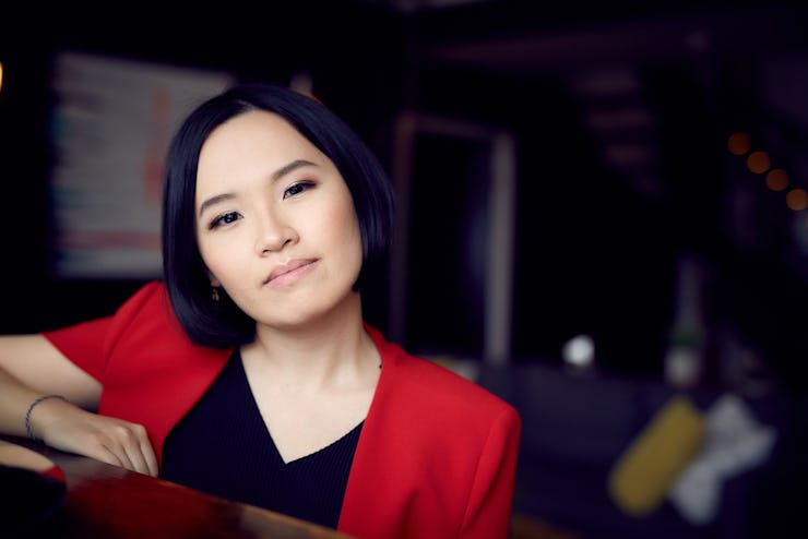 Cherry Rose Tan with her head slightly tilted to the right side in a red-black top