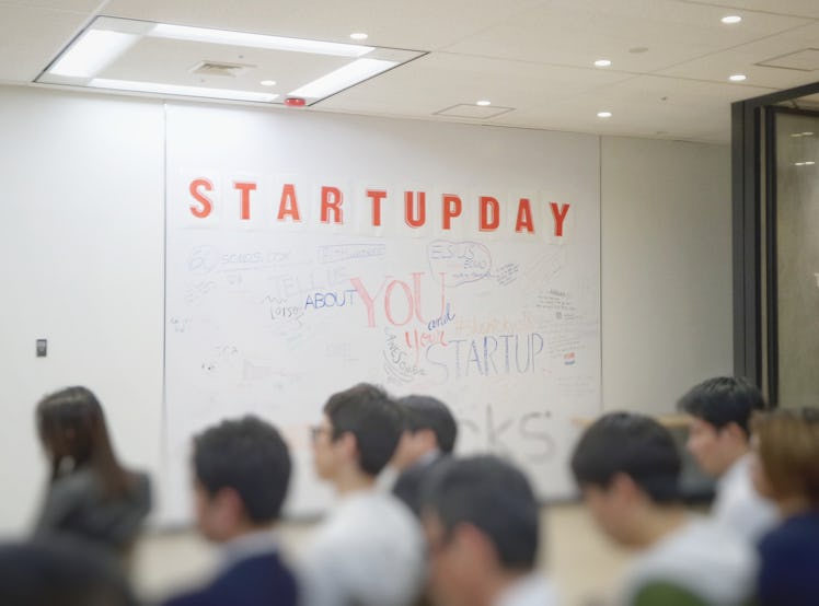 White board with orange "startupday" text
