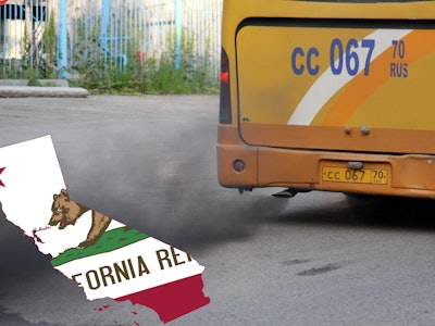 A school bus creating pollution over a torn flag of California