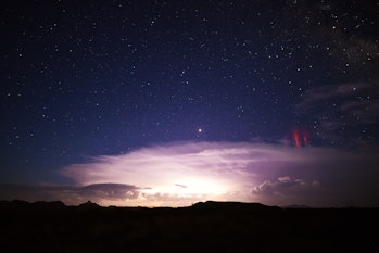 Red sprites (cold plasma lightning) above a powerful thunderstorm.