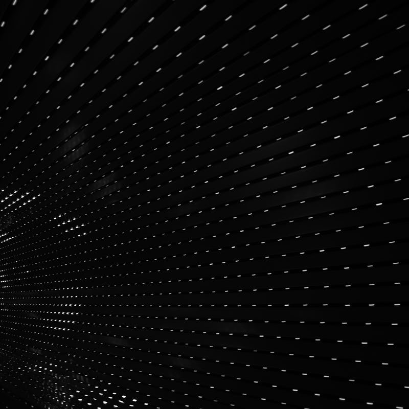 Unsplash photo of white dotted lines on a black background