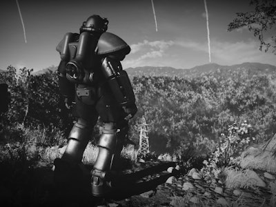 A screenshot from fallout 76 with a man in power armour looking over the wasteland