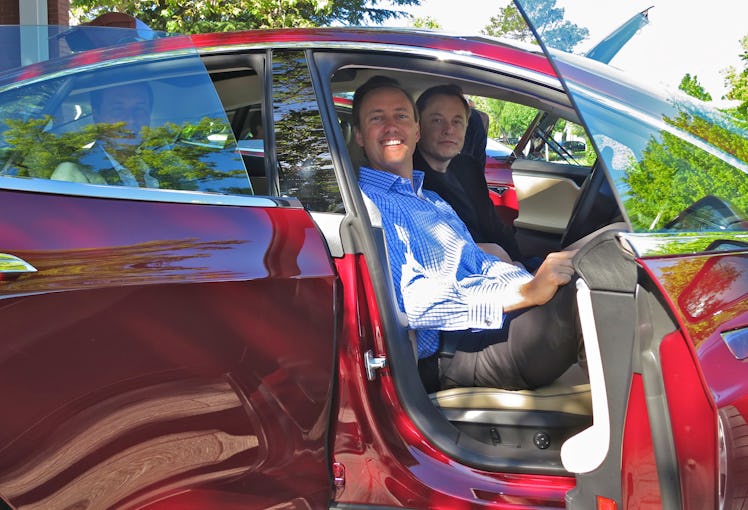 Kimbal and Elon Musk in a Tesla.