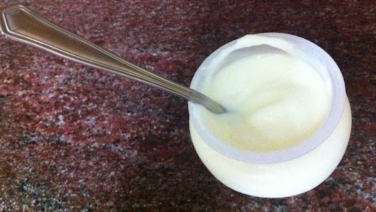 Yogurt in a plastic cup with a spoon