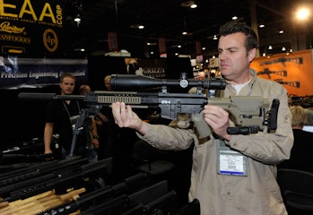 LAS VEGAS, NV - JANUARY 18: Brett DeMille demonstrates an AR-15 rifle with a silencer at the L.A.R./...