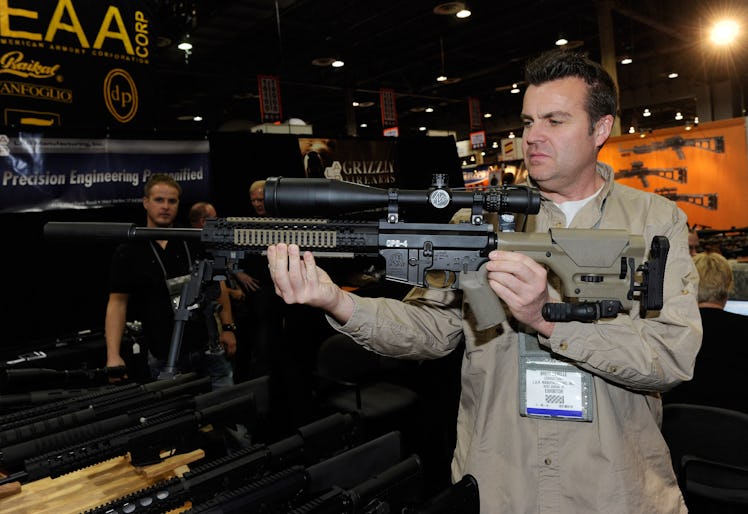 LAS VEGAS, NV - JANUARY 18: Brett DeMille demonstrates an AR-15 rifle with a silencer at the L.A.R./...