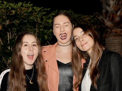 Este, Danielle, and Alana Haim posing for a photo