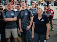 A group of DARPA employees assembled and smiling