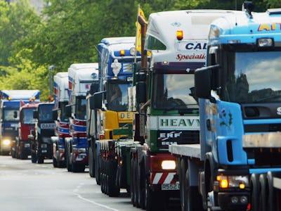 A line of trucks driving down a street