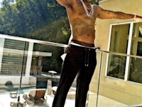 Gucci Mane, who loves 'Game of Thrones' posing topless in black pants and black-white sneakers.